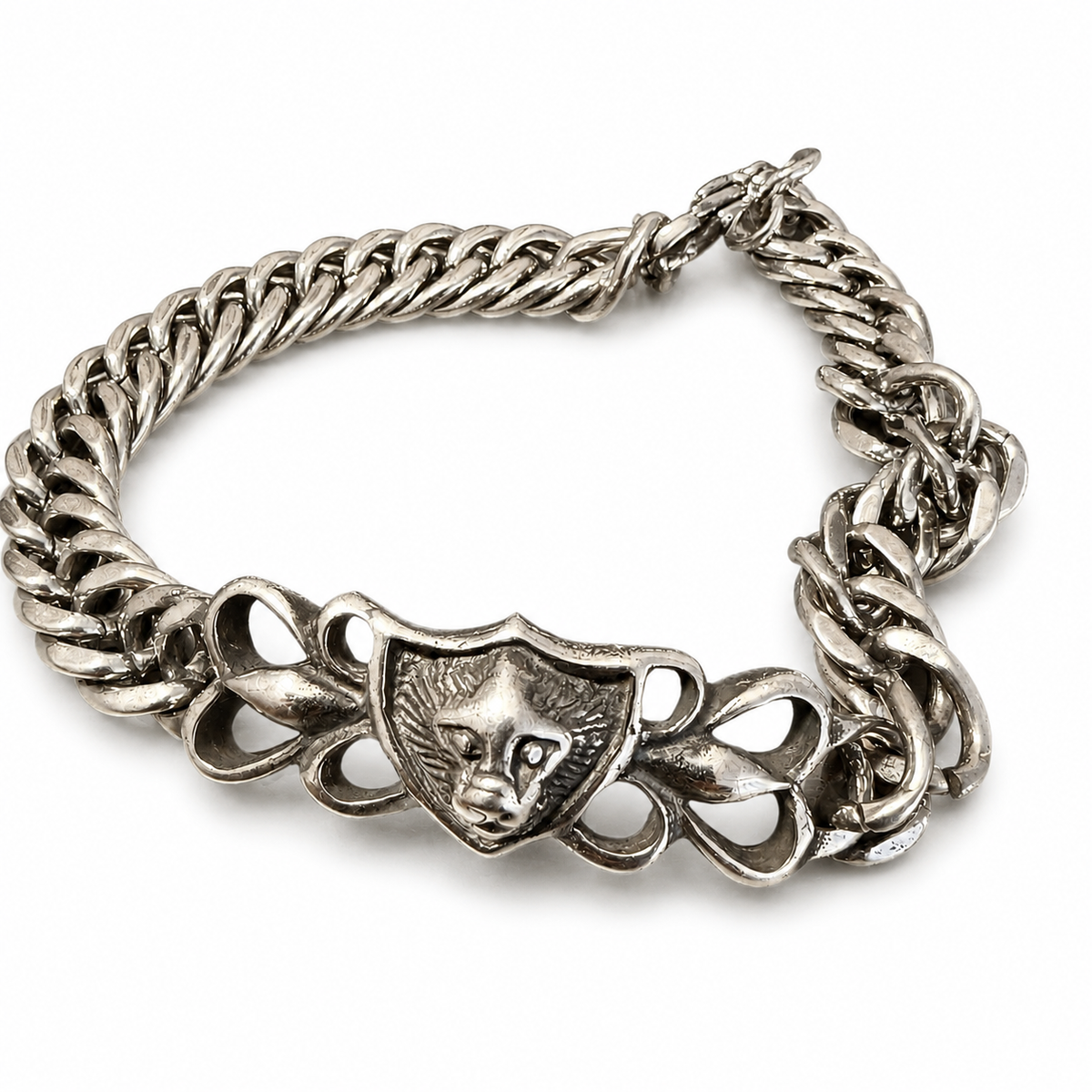 Silver double curb chain bracelet with ornate lion head shield centerpiece